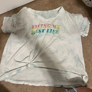 Light blue and white shirt with writing on it